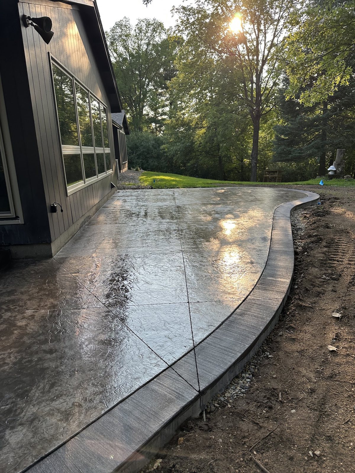 Completed curved stamped concrete patio with contrasting border
