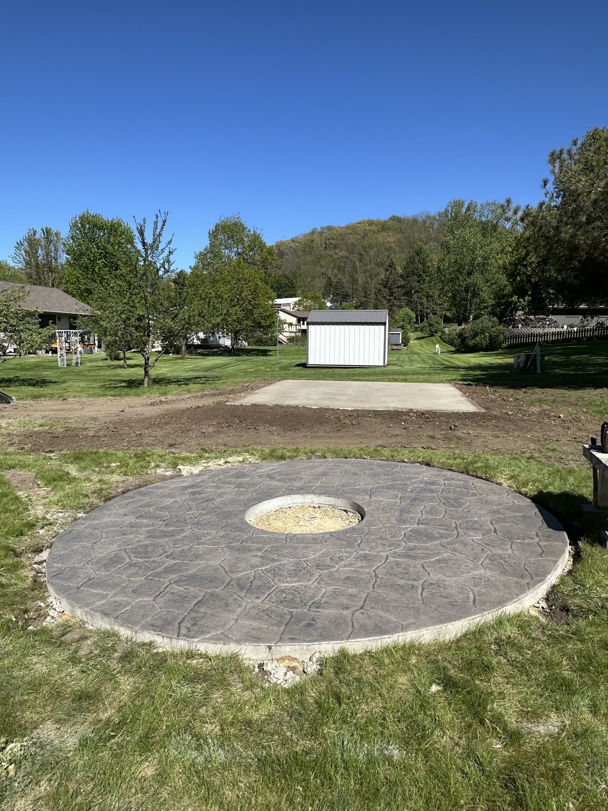 Circular Fire-Pit Pad — Completed decorative concrete circle built as an outdoor gathering feature.