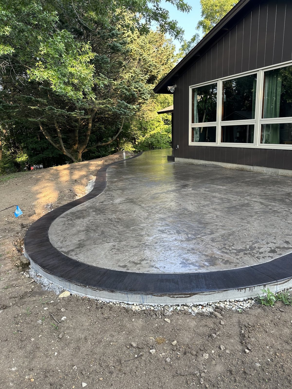 Decorative Patio Finish — Stamped surface and dark border defining the outdoor space.