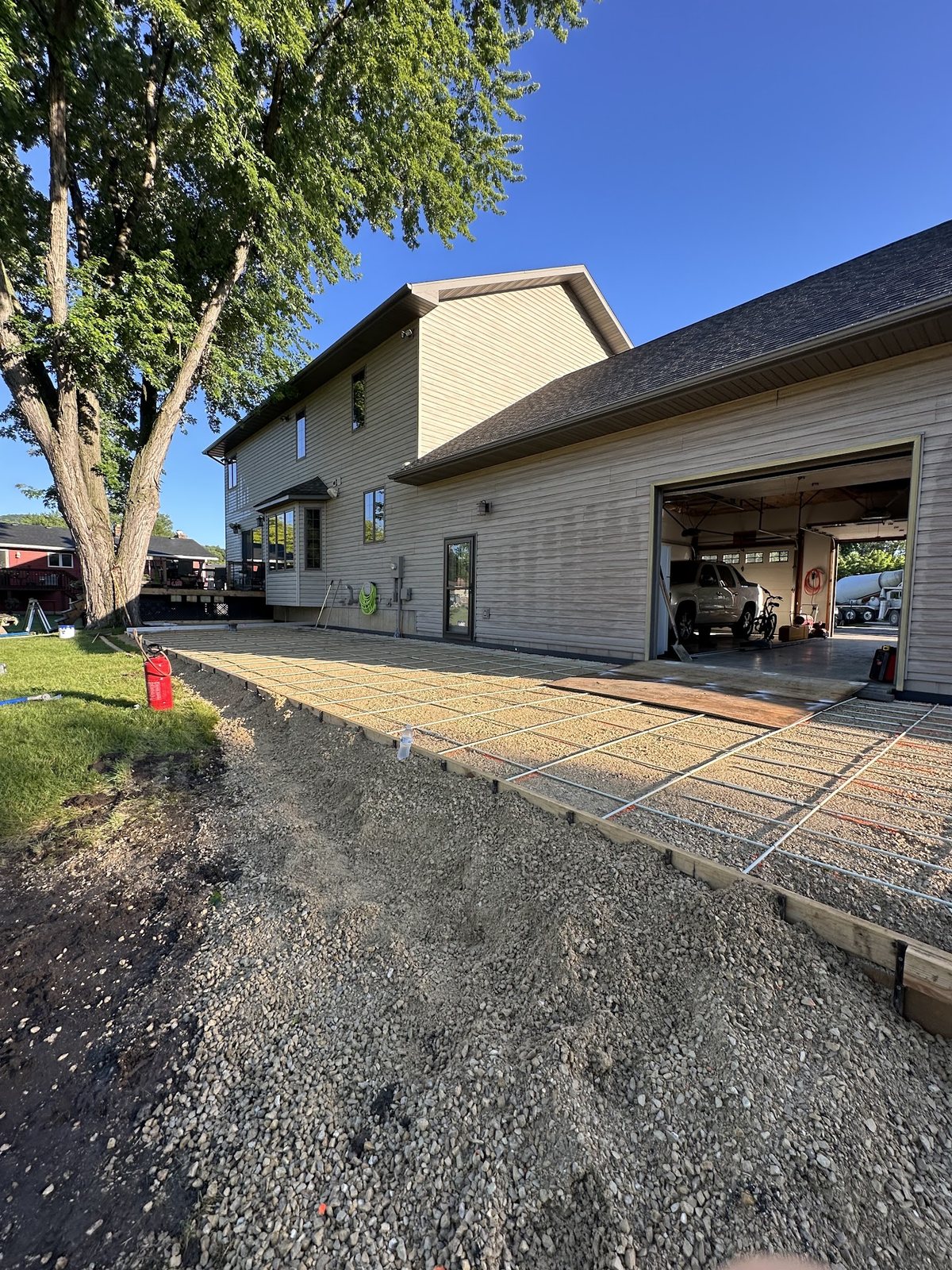 Backyard Patio Reinforcement — Formed and reinforced patio prepared next to the garage and home.