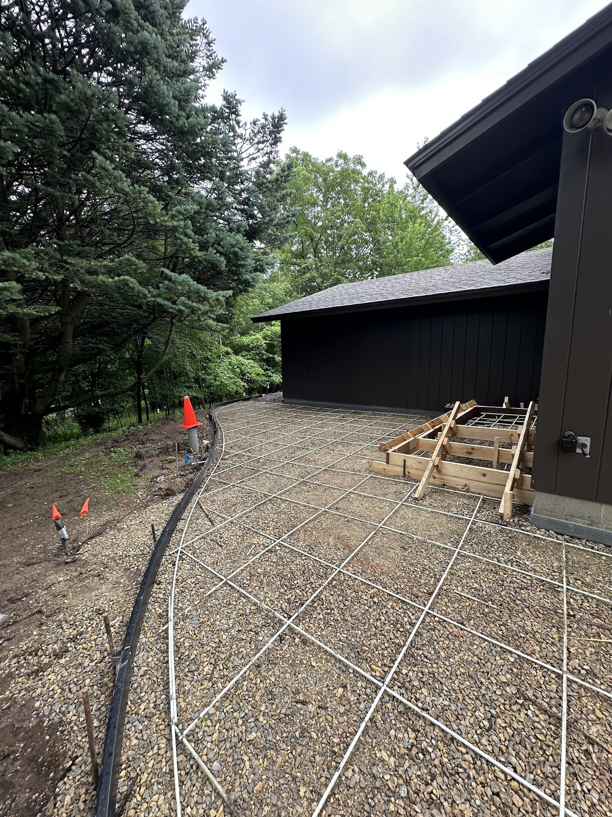 Stamped Patio Layout — Curved footprint, base and reinforcement ready before placement.