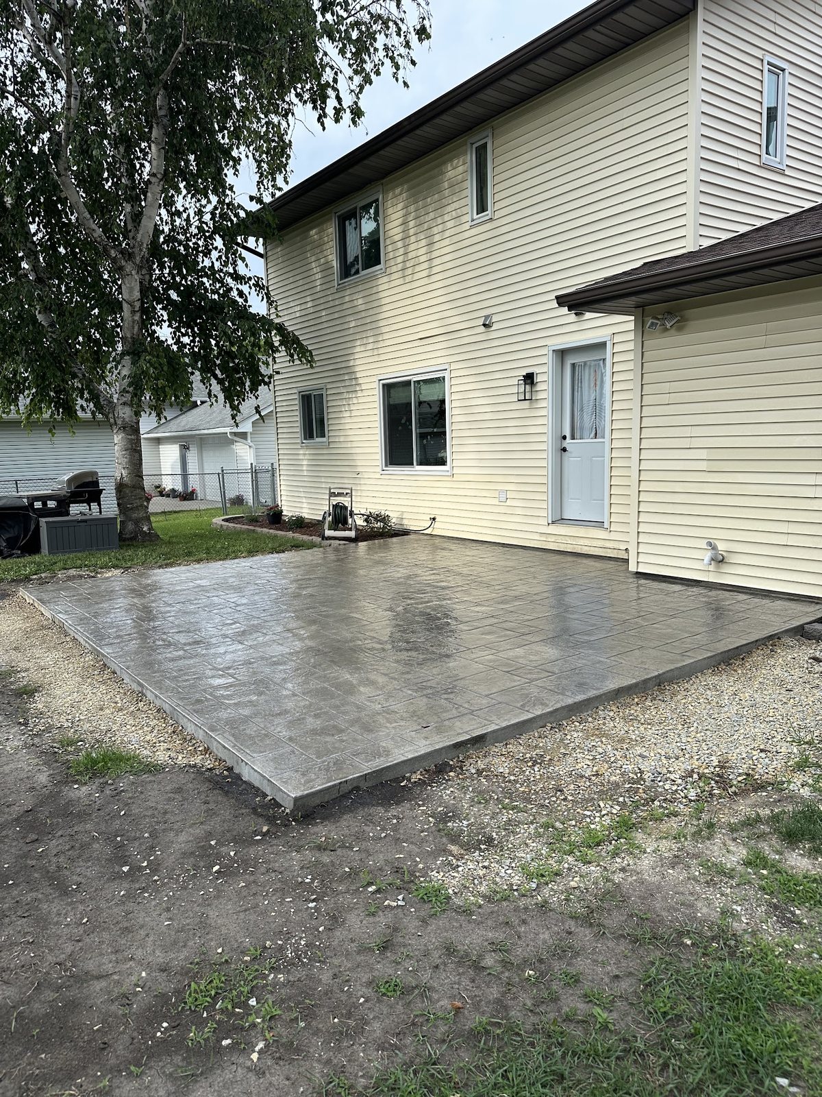 Fresh Backyard Patio — Finished patio surface photographed while the concrete is still curing.